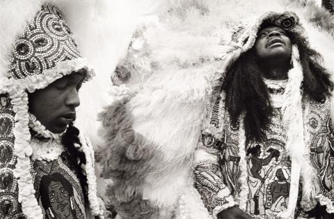 Back and white photograph shows two Black men in elaborate headdresses and ceremonial clothing