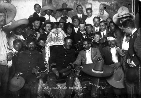 Francisco (Pancho) Villa, in the presidential chair, with Emiliano Zapata to his right. Mexico City, 1914.