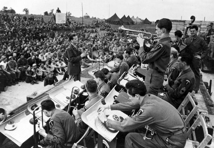Maj. Glenn Miller conducts the band during an open air concert. 