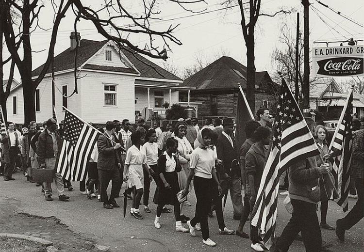 Participants, some carrying American flags, marching in the civil rights march from Selma to Montgomery, Alabama in 1965.