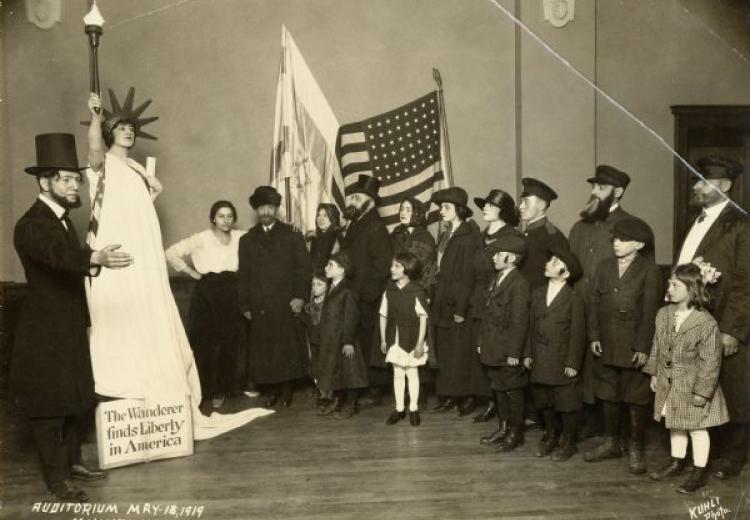 people gathered around Abe Lincoln and the Statue of Liberty