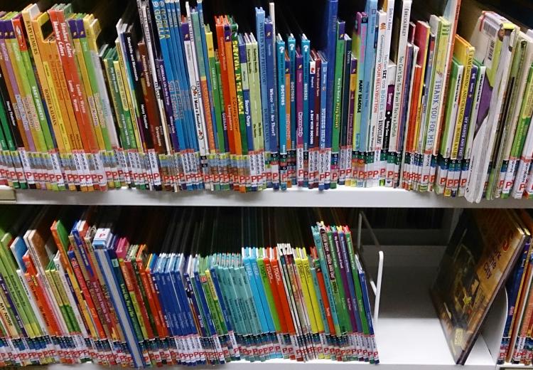 Colorful children's book spines on library shelves