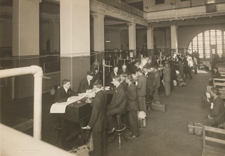 Immigrants being registered at one end of the Main Hall, U. S. Immigration Station.