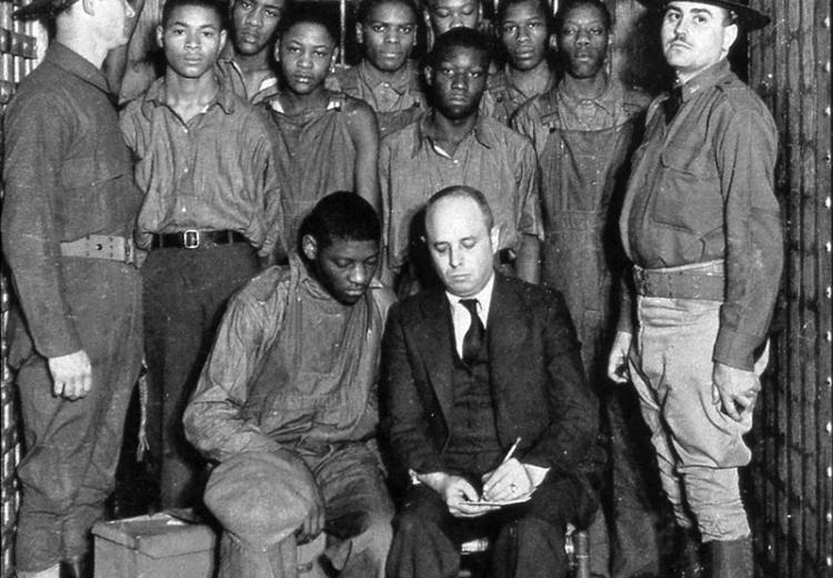 The Scottsboro Boys with their lawyer and guards